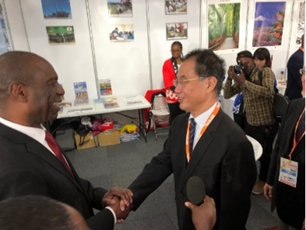 写真　ロザリオ首相（左）のジャパンパビリオン視察を歓迎する池田敏雄・駐モザンビーク大使（ジェトロ撮影）